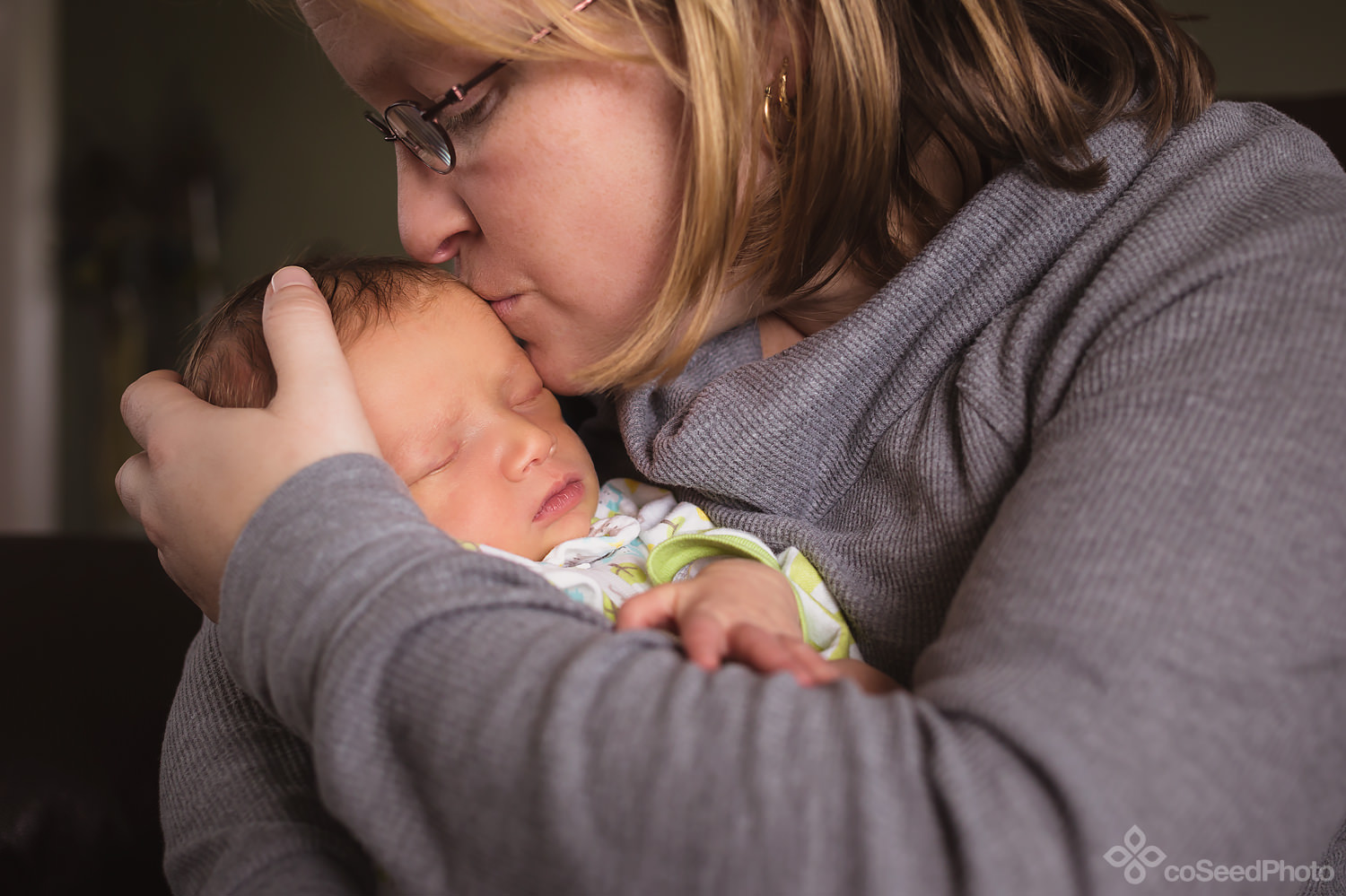 Nicole kisses newborn Declan on the head.