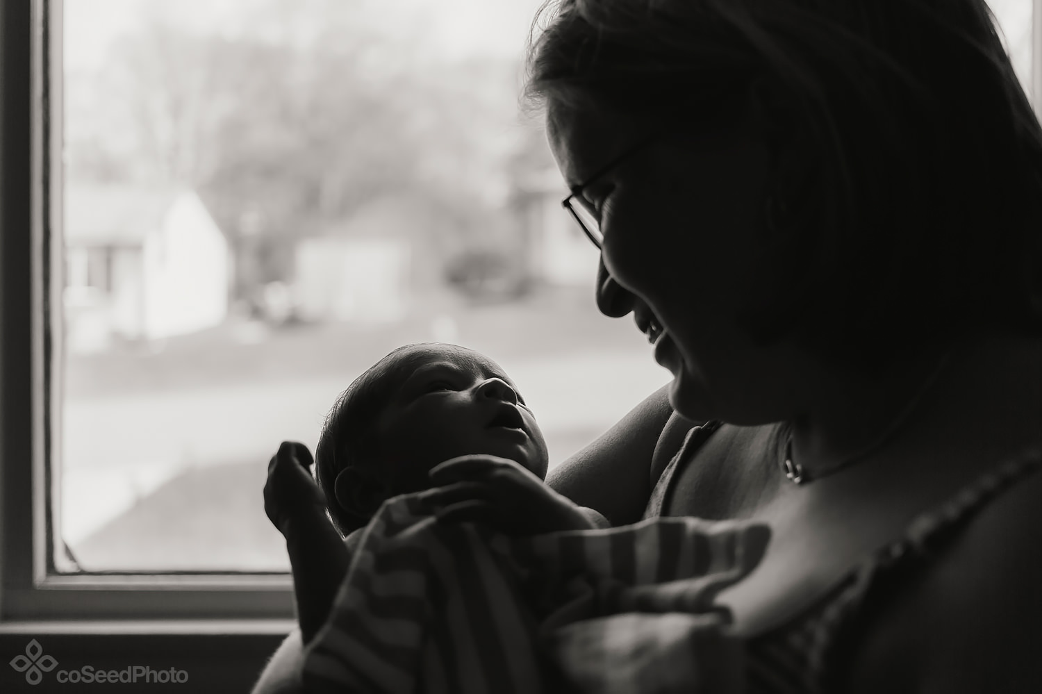 Nicole and Declan standing backlit by the window.