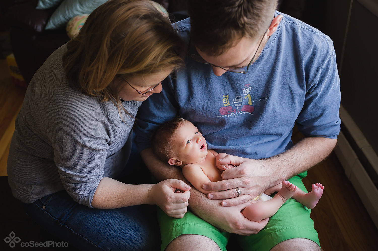 Matt and Nicole sit with newborn Declan in their lap.