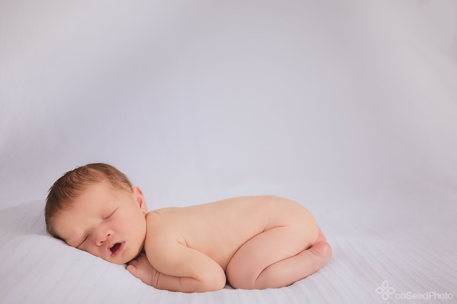 Newborn Declan all curled up.