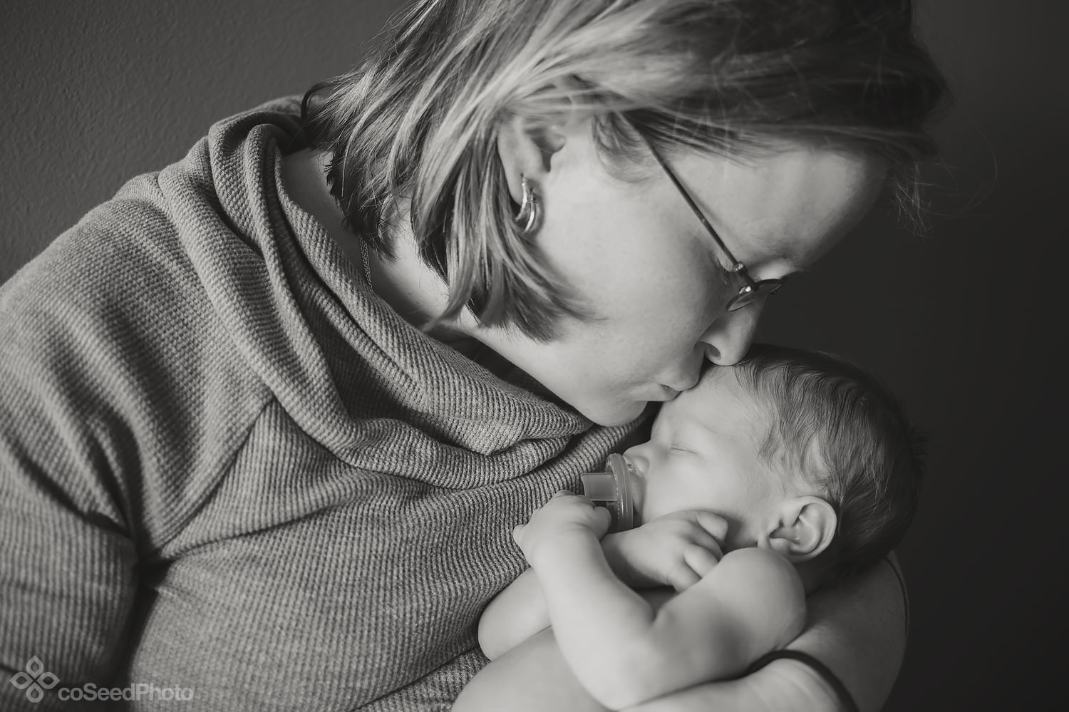 Nicole kisses newborn Declan on the forehead.