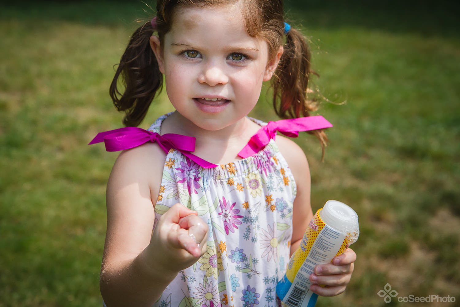 Elise catches a bubble on her finger.
