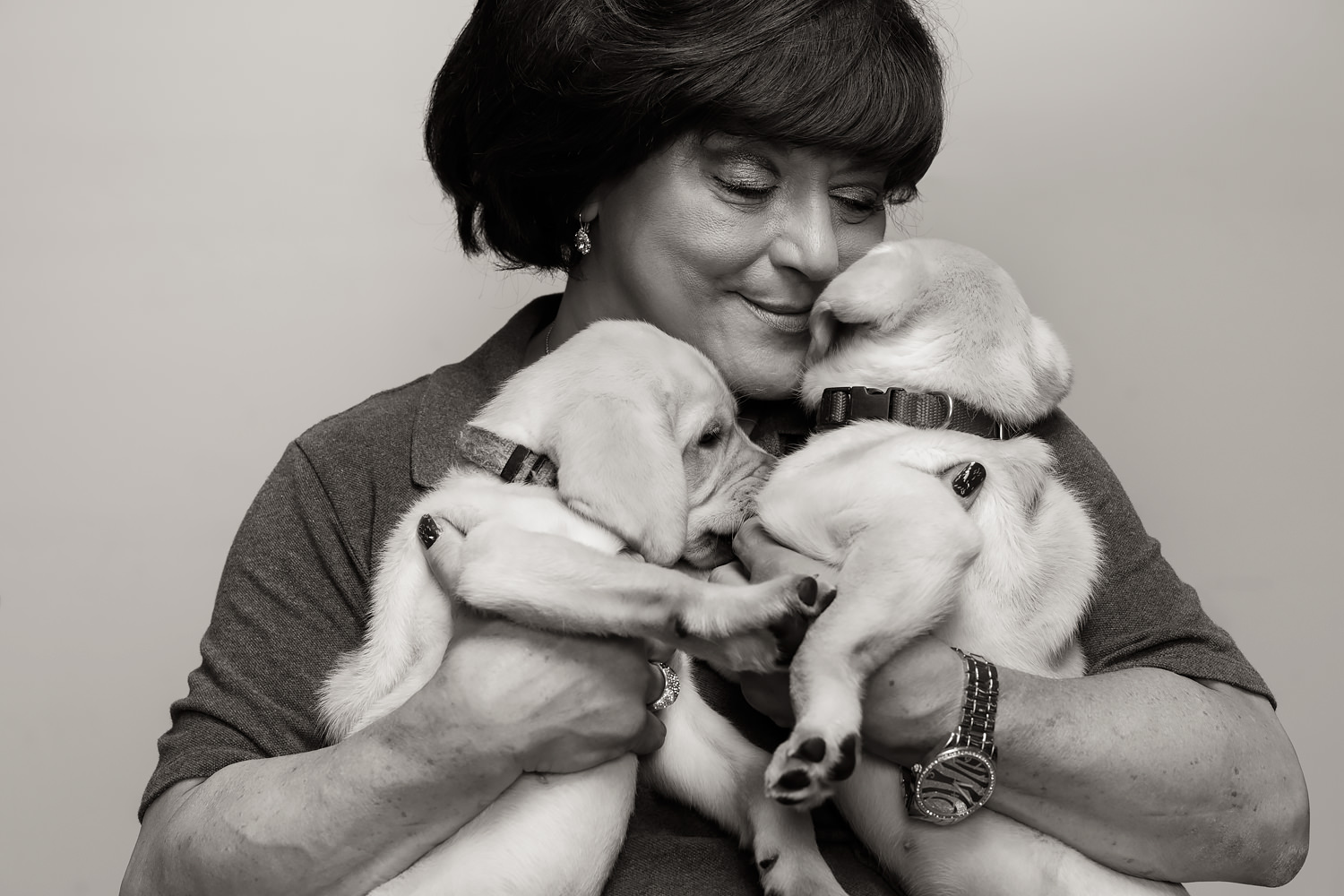 Guiding Eyes Breeding Kennel Manager Maria with two yellow lab puppies.